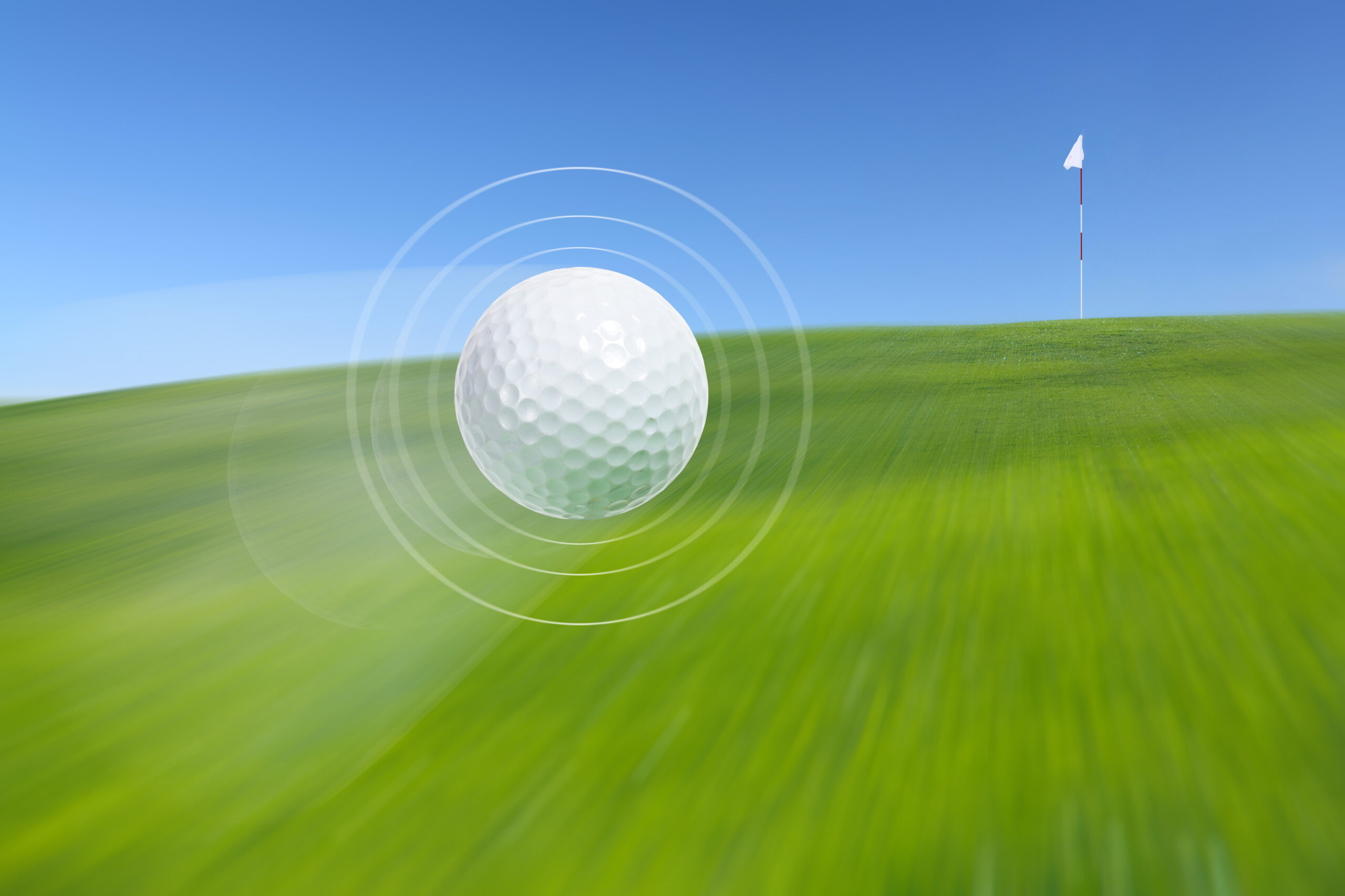 Golf ball in motion moving towards the hole